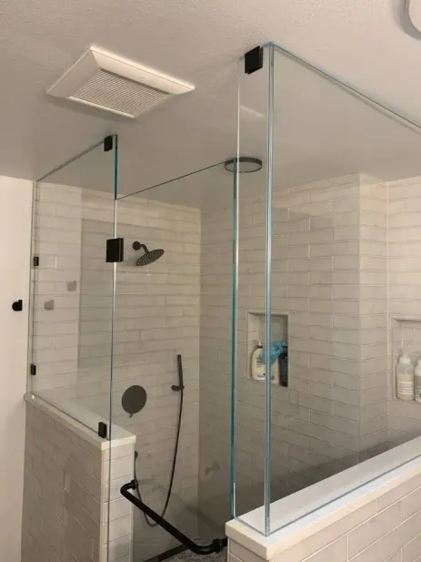 Modern dark bathroom remodel with skylight and pebble shower floor