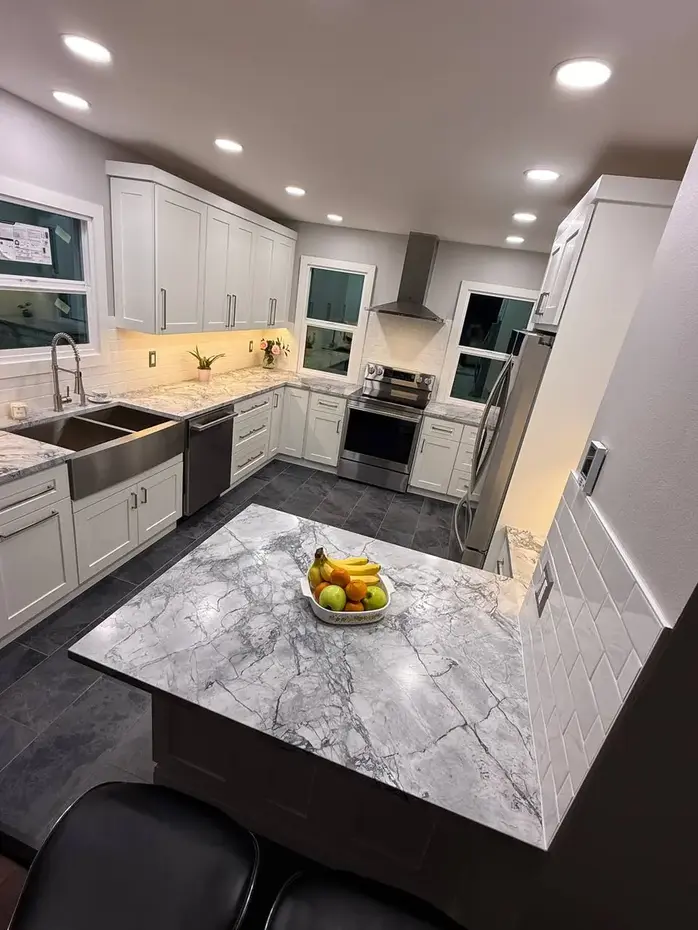 White quartz countertop with waterfall edge and dark cabinets