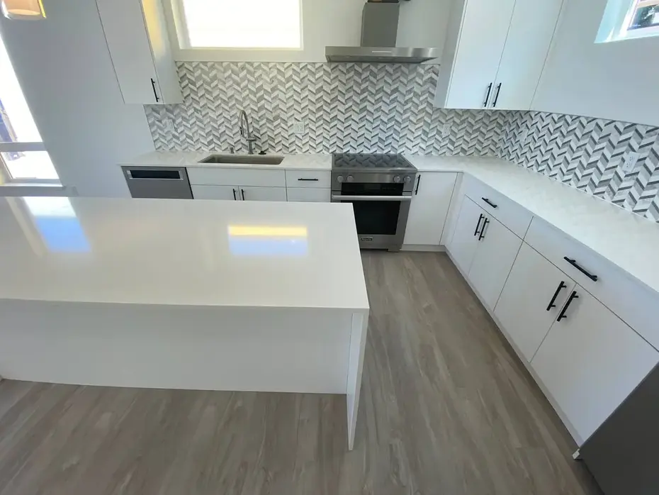 Gray kitchen with quartz island countertop and smart refrigerator