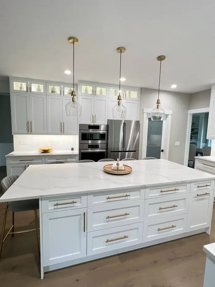 Quartz island countertop with bar stools and gold pendant lights
