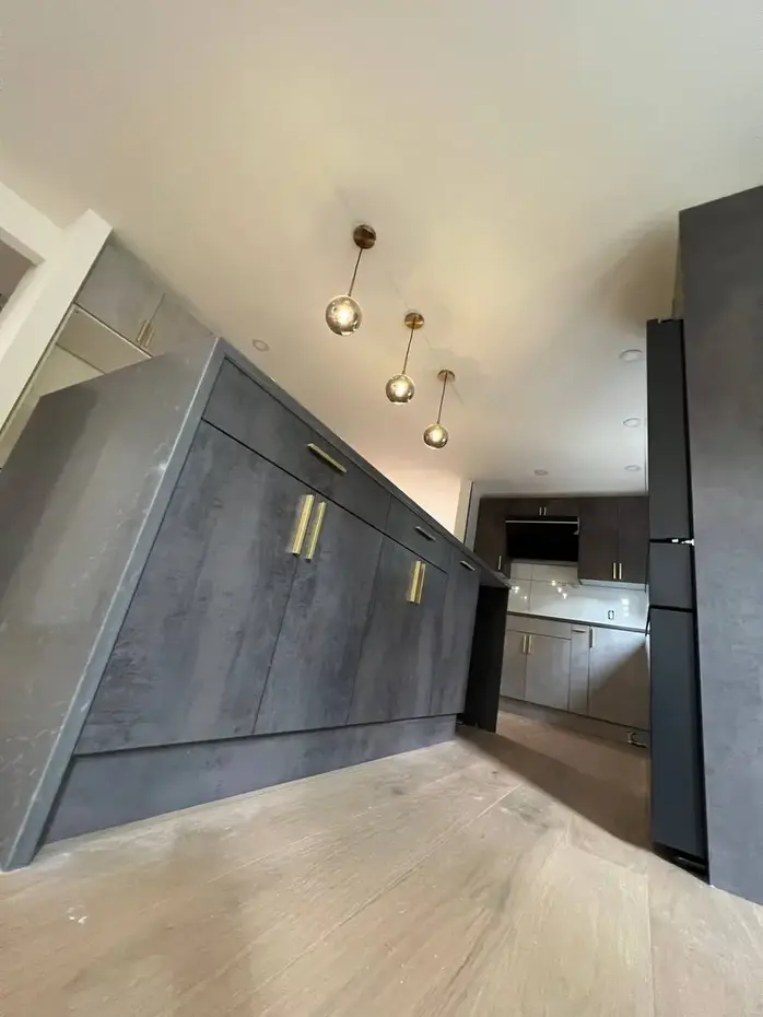 Gray concrete-style kitchen cabinets with pendant lighting Bellevue